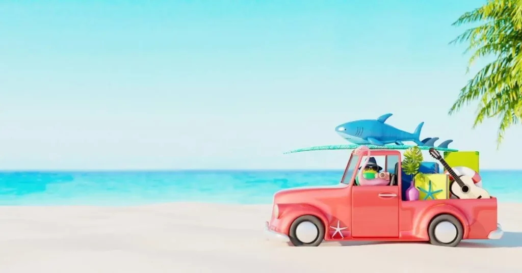 A pink truck headed on vacation to the beach.