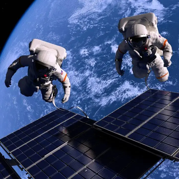 Two astronauts doing a spacewalk at the international space station.